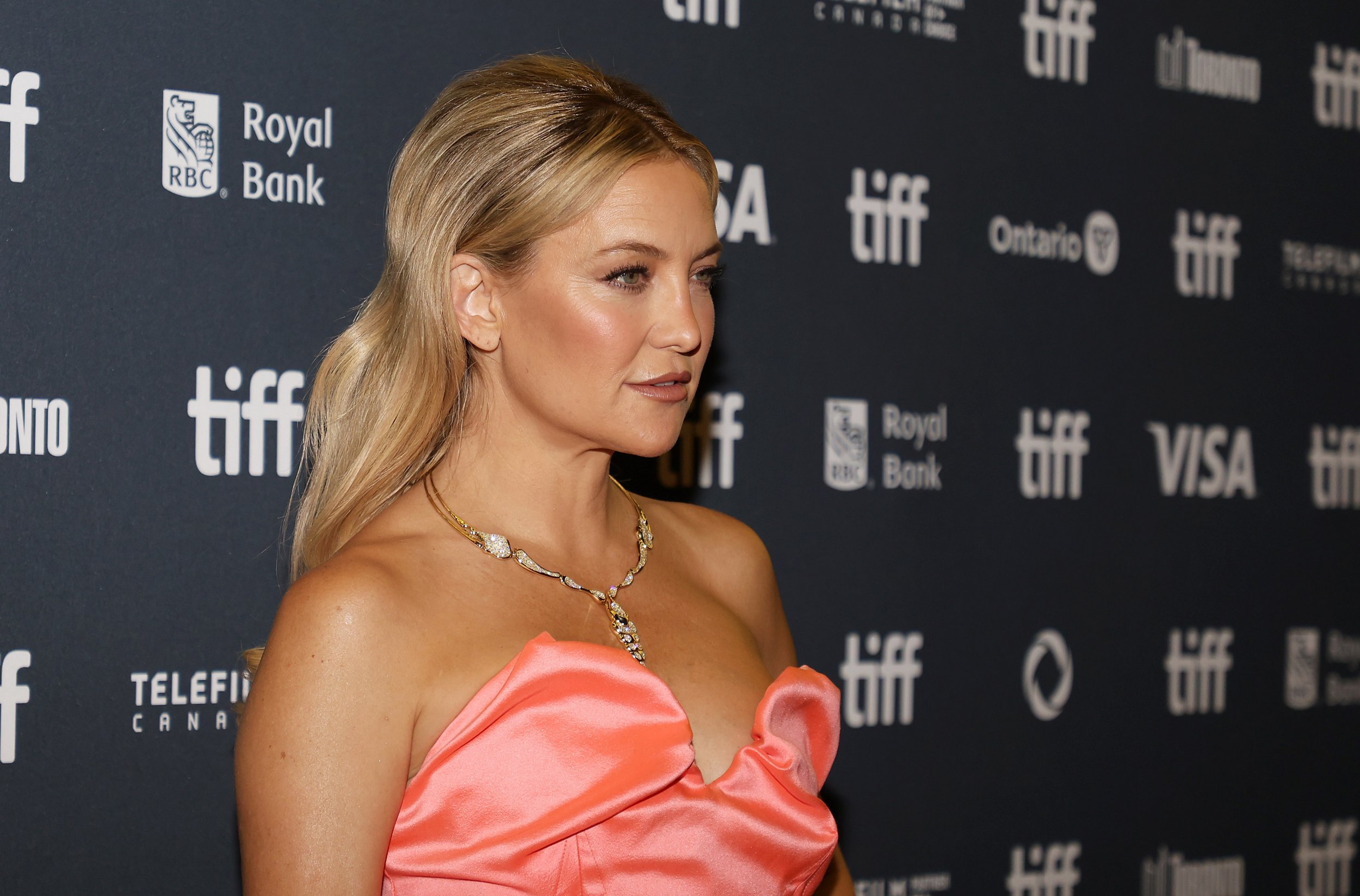 Kate Hudson poses in a coral dress at the Toronto Film Festival in Canada